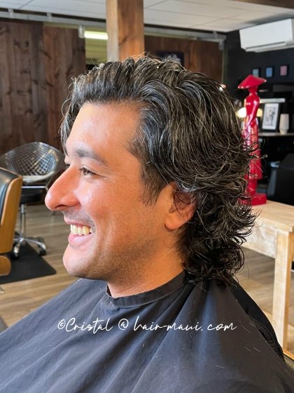 Modern long men's haircut with textured layers by Cristal D. in Maui